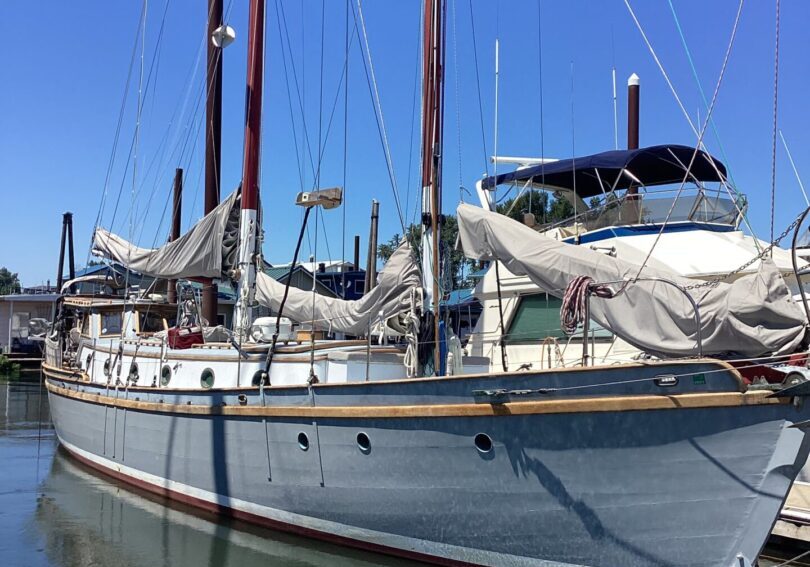 Sailboat docked in a sunny marina.